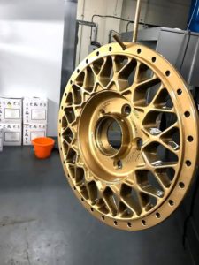 Refurbished alloy wheel with new colour that is gold