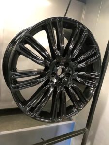 refurbished alloy wheel that has had a new paint job which is black