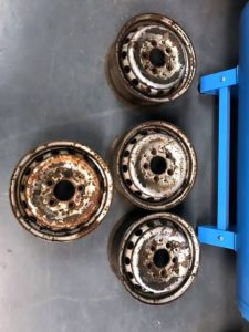 4 rusted steel alloy wheels before